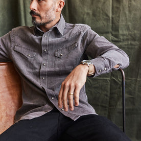 fit model sitting wearing The Western Shirt in Soil Pigment Selvage Denim