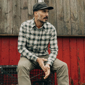 fit model sitting wearing The Western Shirt in Wetland Plaid