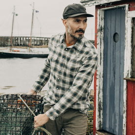 fit model holding a bucket wearing The Western Shirt in Wetland Plaid