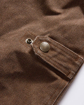material shot of the cinching detail on The Workhorse Vest in Aged Penny Chipped Canvas, Outerwear by Taylor Stitch