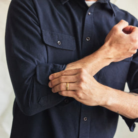 fit model adjusting the cuffs on The Yosemite Shirt in Dark Navy