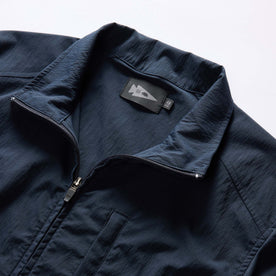 material shot of the collar on The Deploy Packable Shell in Dark Navy
