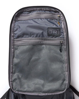 flatlay of the inside of the front flap on The GR1 USA in Raindrop Camo Ripstop WashWax, Accessories by Taylor Stitch