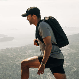 fit model walking wearing The Performance TAC Hat in Black