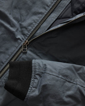 material shot of the YKK two way separating zipper on The Bomber Jacket in Charcoal Dry Wax, Outerwear by Taylor Stitch