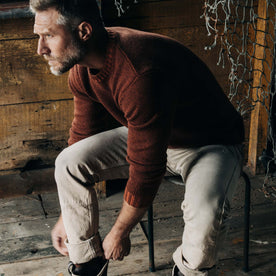 fit model putting on his shoes in The Headland Sweater in Spiced Rum