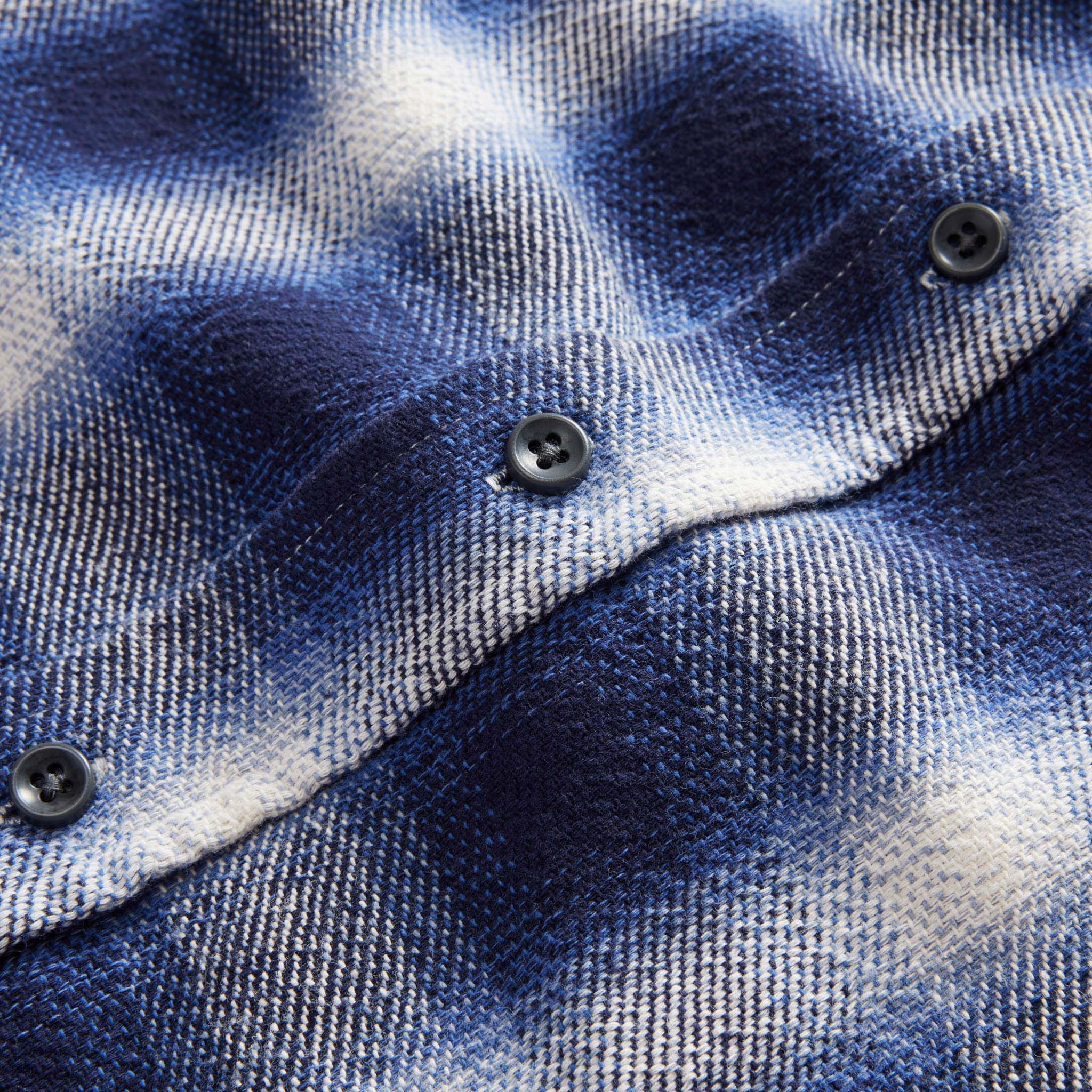 material shot of the buttons on The Ledge Shirt in Blue Sky Plaid, Wovens by Taylor Stitch