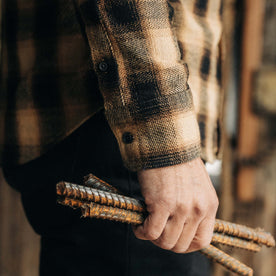 fit model showing the cuffs on The Ledge Shirt in Brass Plaid