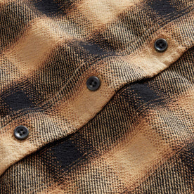 material shot of the charcoal buttons on The Ledge Shirt in Brass Plaid