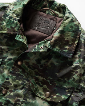 material shot of the collar and TS x Danner embossed patch on The Venture Jacket in Painted Camo Waxed Canvas, Outerwear by Taylor Stitch