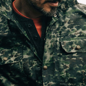 fit model showing the front snap buttons on The Venture Jacket in Painted Camo Waxed Canvas