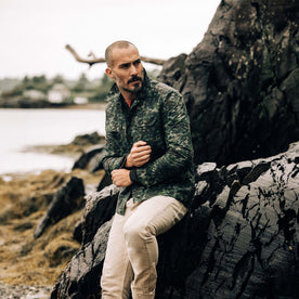 fit model adjusting the sleeves on The Venture Jacket in Painted Camo Waxed Canvas