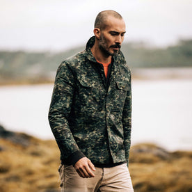 fit model walking in The Venture Jacket in Painted Camo Waxed Canvas