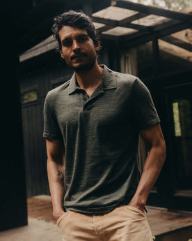fit model posing in The Merino Polo in Heather Army, Knits by Taylor Stitch