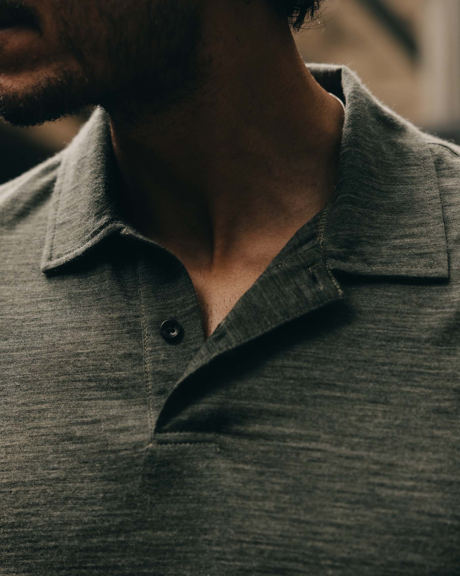 fit model showing off the collar on The Merino Polo in Heather Army, Knits by Taylor Stitch