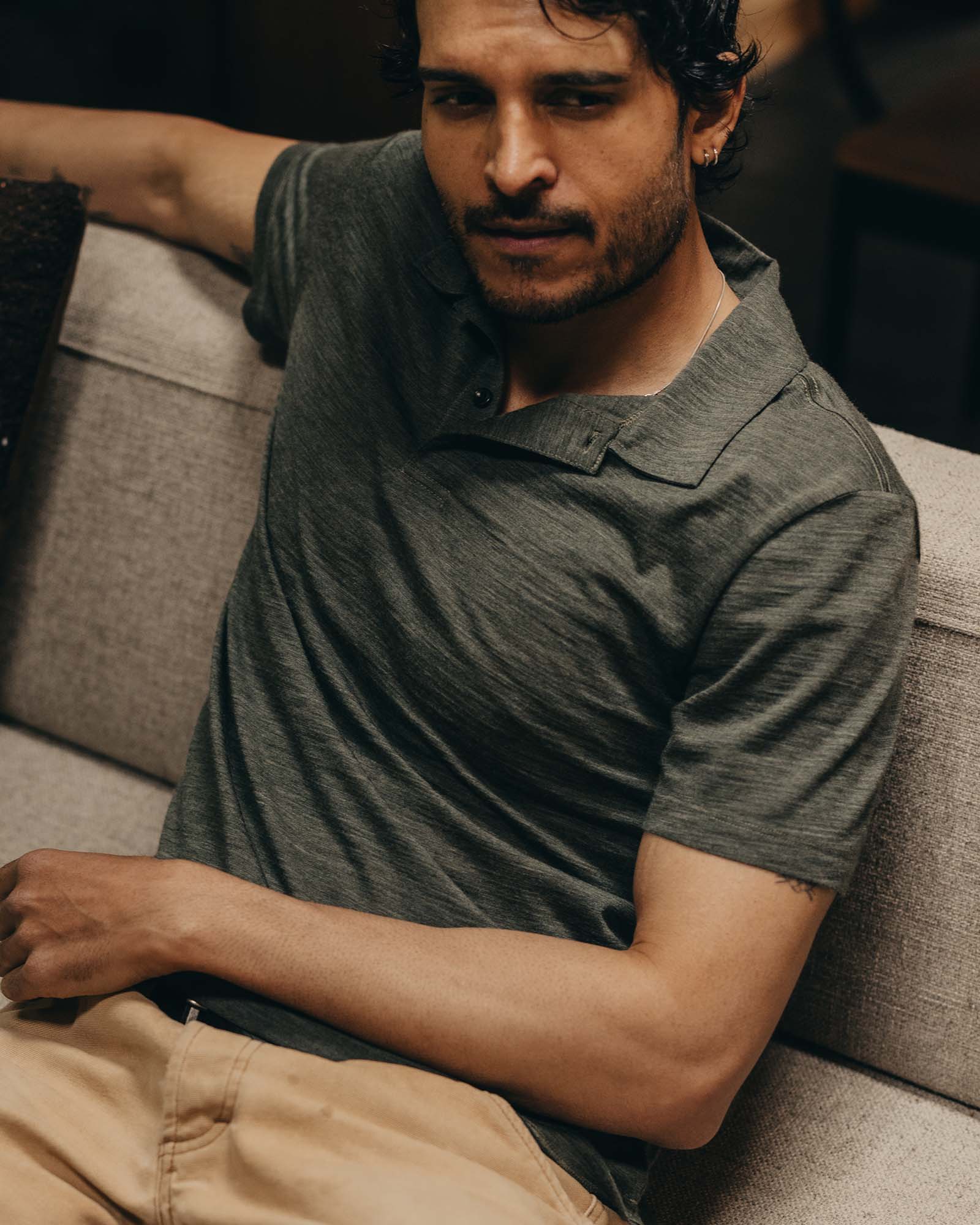 fit model sitting wearing The Merino Polo in Heather Army, Knits by Taylor Stitch