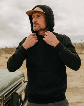 fit model showing off the hood of The Apres Hoodie in Black Indigo Terry, Knits by Taylor Stitch