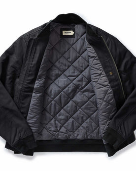 flatlay of The Insulated Bomber Jacket in Coal Dry Wax, shown open, Outerwear by Taylor Stitch