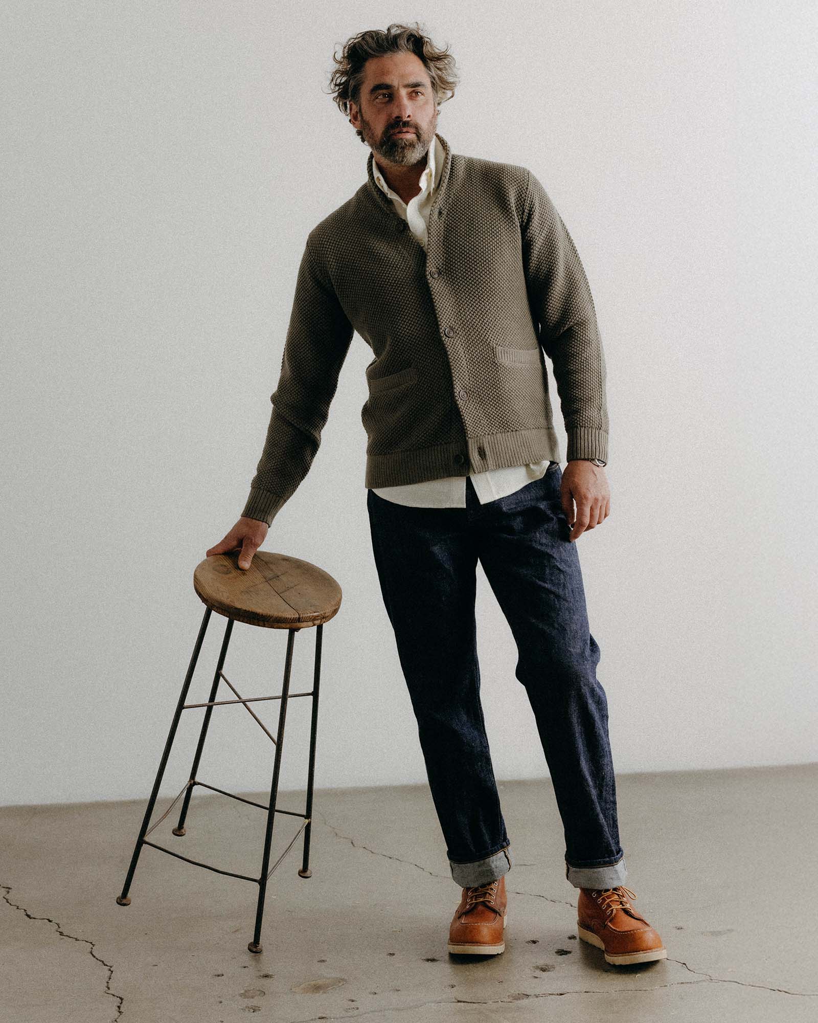 fit model with his hand in his pocket wearing The Crawford Sweater in Fatigue Olive, Knits by Taylor Stitch