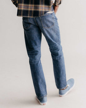fit model showing off the back of The Democratic Jean in Mid Wash Organic Selvedge, Bottoms by Taylor Stitch