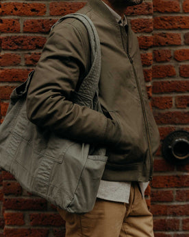fit model holding The Foundation Tote in Organic Smoked Olive, Accessories by Taylor Stitch