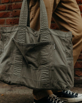 fit model showing off The Foundation Tote in Organic Smoked Olive, Accessories by Taylor Stitch