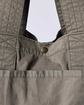 editorial image of the button snap on The Foundation Tote in Organic Smoked Olive, Accessories by Taylor Stitch