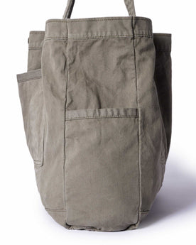 editorial image of the side pocket on The Foundation Tote in Organic Smoked Olive, Accessories by Taylor Stitch