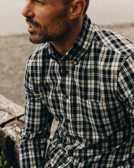 fit model showing off buttons on The Jack in Rinsed Indigo Plaid, Wovens by Taylor Stitch