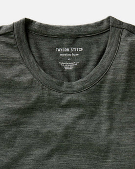 fit model lying on the ground wearing The Merino Tee in Heather Army, Knits by Taylor Stitch