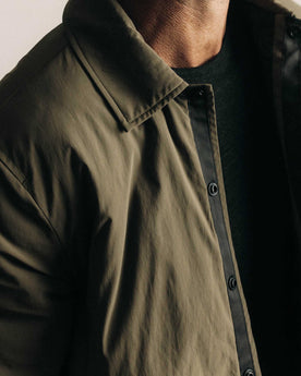 fit model showing off the buttons on The Ridgeline Overshirt in Fatigue Olive, Wovens by Taylor Stitch