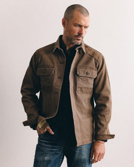 fit model sitting wearing The Shop Shirt in Aged Penny Chipped Canvas, Wovens by Taylor Stitch
