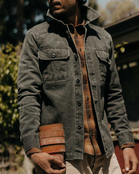 fit model holding planters wearing The Shop Shirt in Coal Chipped Canvas, Wovens by Taylor Stitch