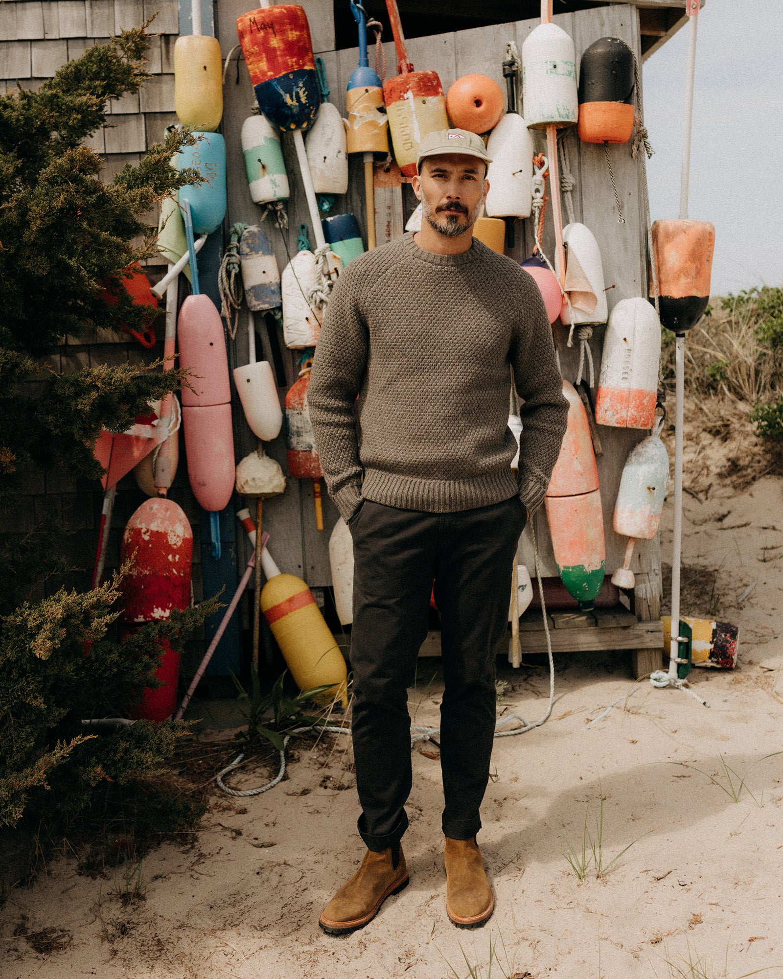 fit model with his hands in his pockets wearing The Slim Foundation Pant in Organic Faded Black, Bottoms by Taylor Stitch