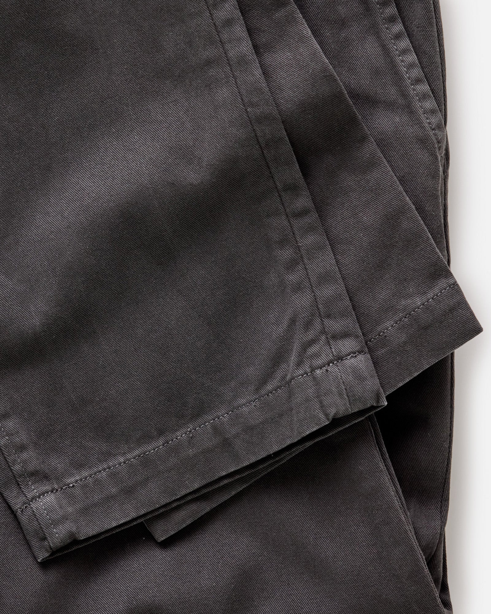 material shot of the leg cuffs on The Slim Foundation Pant in Organic Faded Black, Bottoms by Taylor Stitch