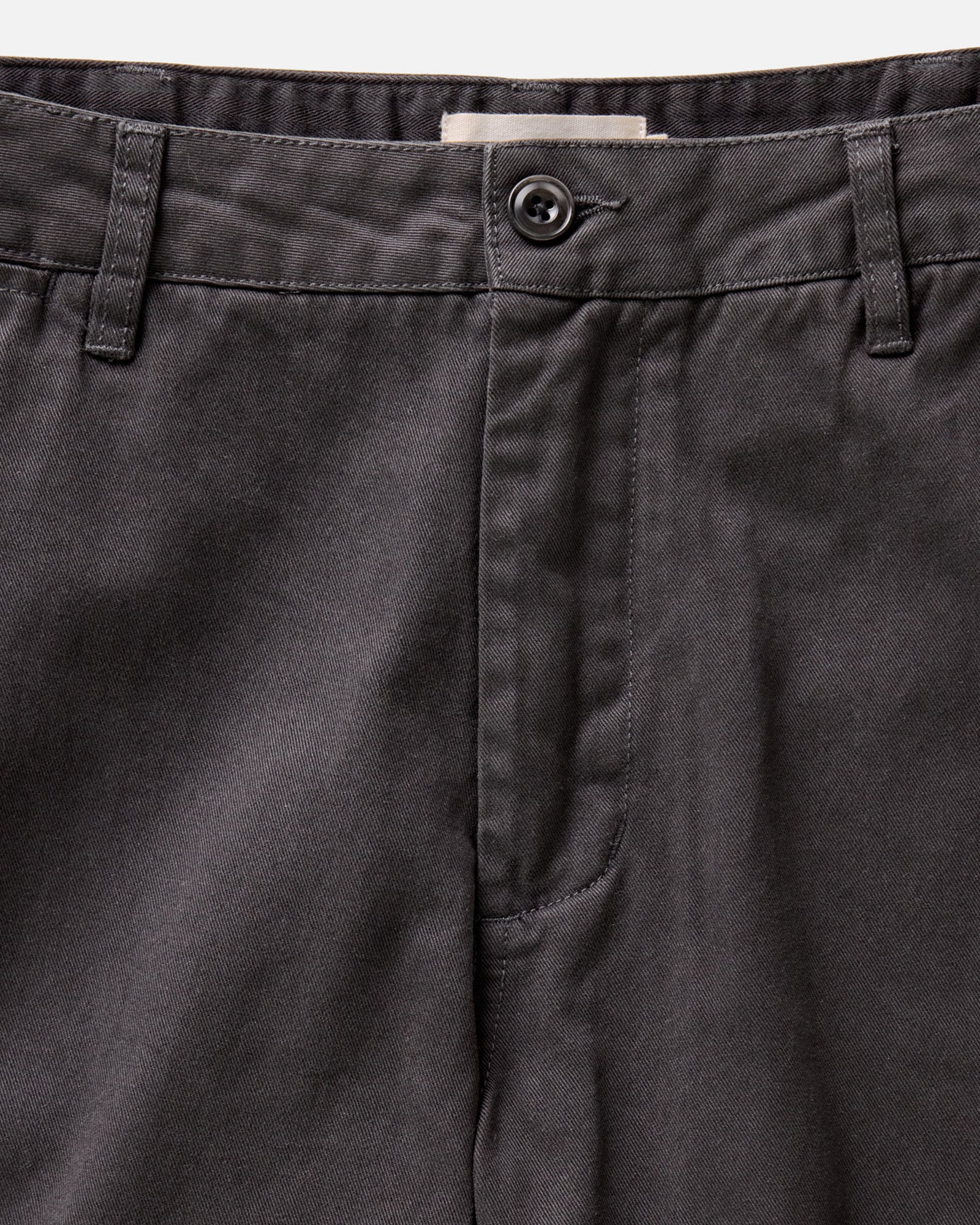 material shot of the button fly on The Slim Foundation Pant in Organic Faded Black, Bottoms by Taylor Stitch