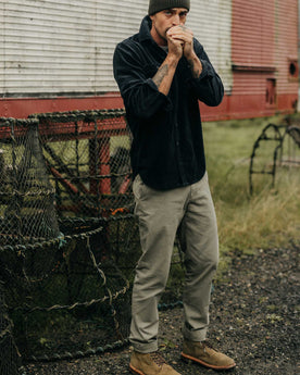 fit model posing in The Slim Foundation Pant in Organic Smoked Olive, Bottoms by Taylor Stitch