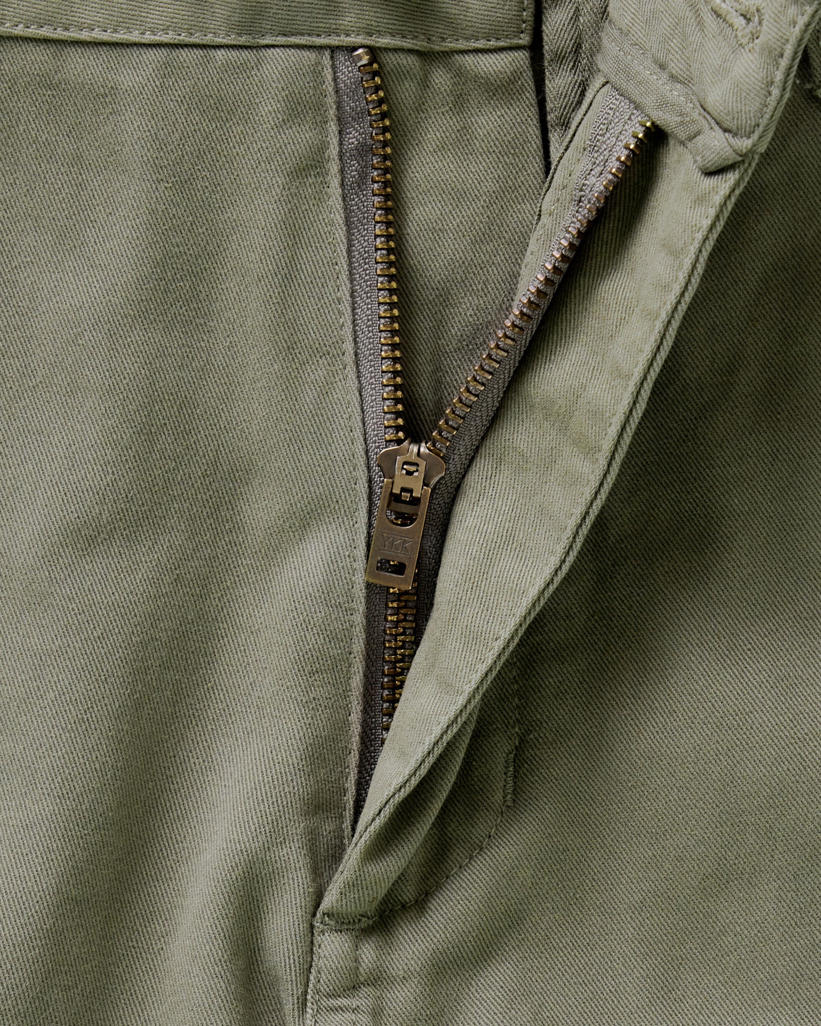 material shot of the zipper on The Slim Foundation Pant in Organic Smoked Olive, Bottoms by Taylor Stitch