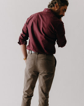 fit model sitting wearing The Slim Foundation Pant in Organic Espresso, Bottoms by Taylor Stitch