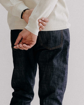 fit model showing off the back of The Slim Jean in Rigid Organic Selvedge, Bottoms by Taylor Stitch
