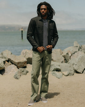 fit model posing in The Surplus Pant in Field Olive Reverse Sateen, Bottoms by Taylor Stitch