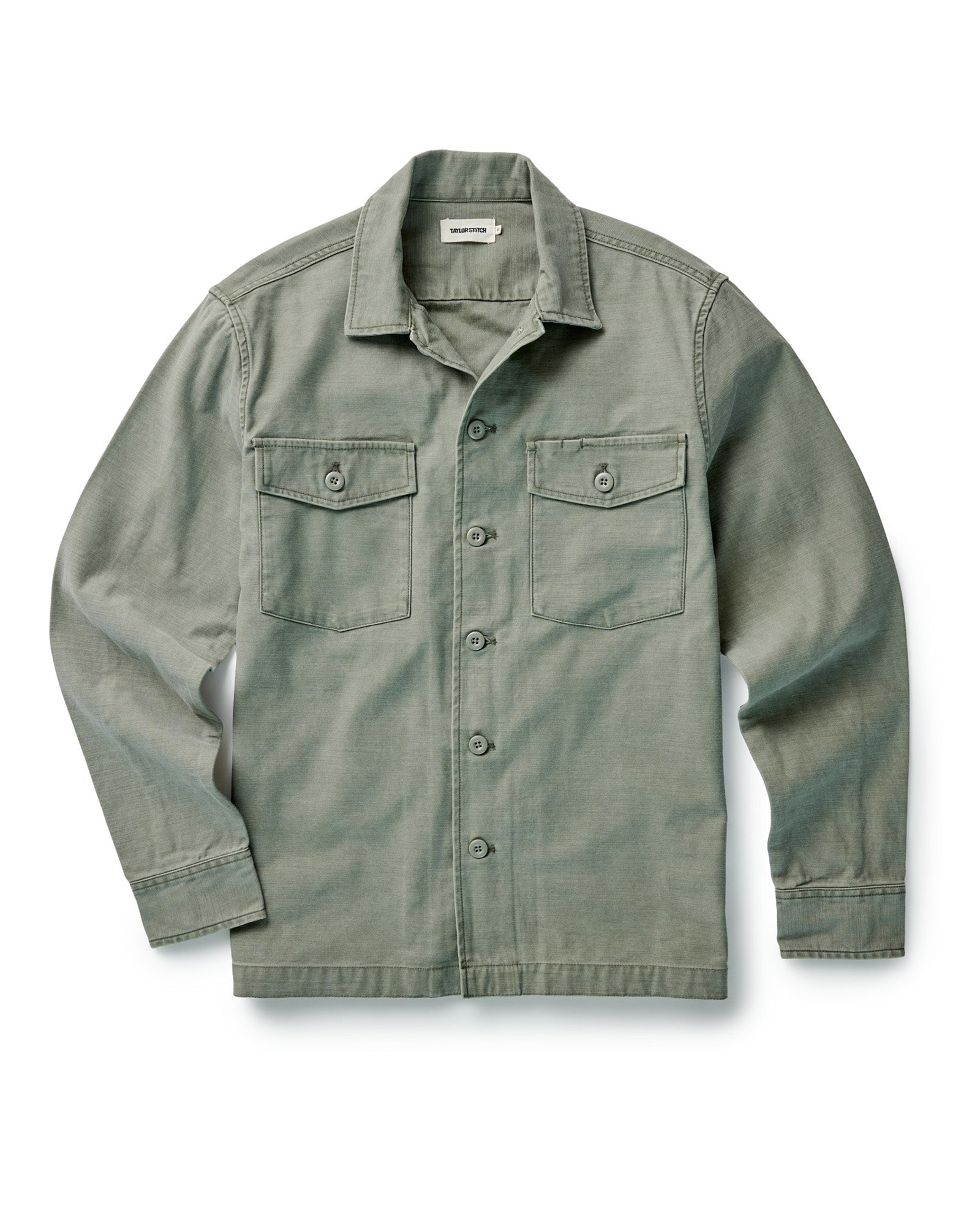 editorial image of The Surplus Shirt in Field Olive Reverse Sateen on a rock, Wovens by Taylor Stitch