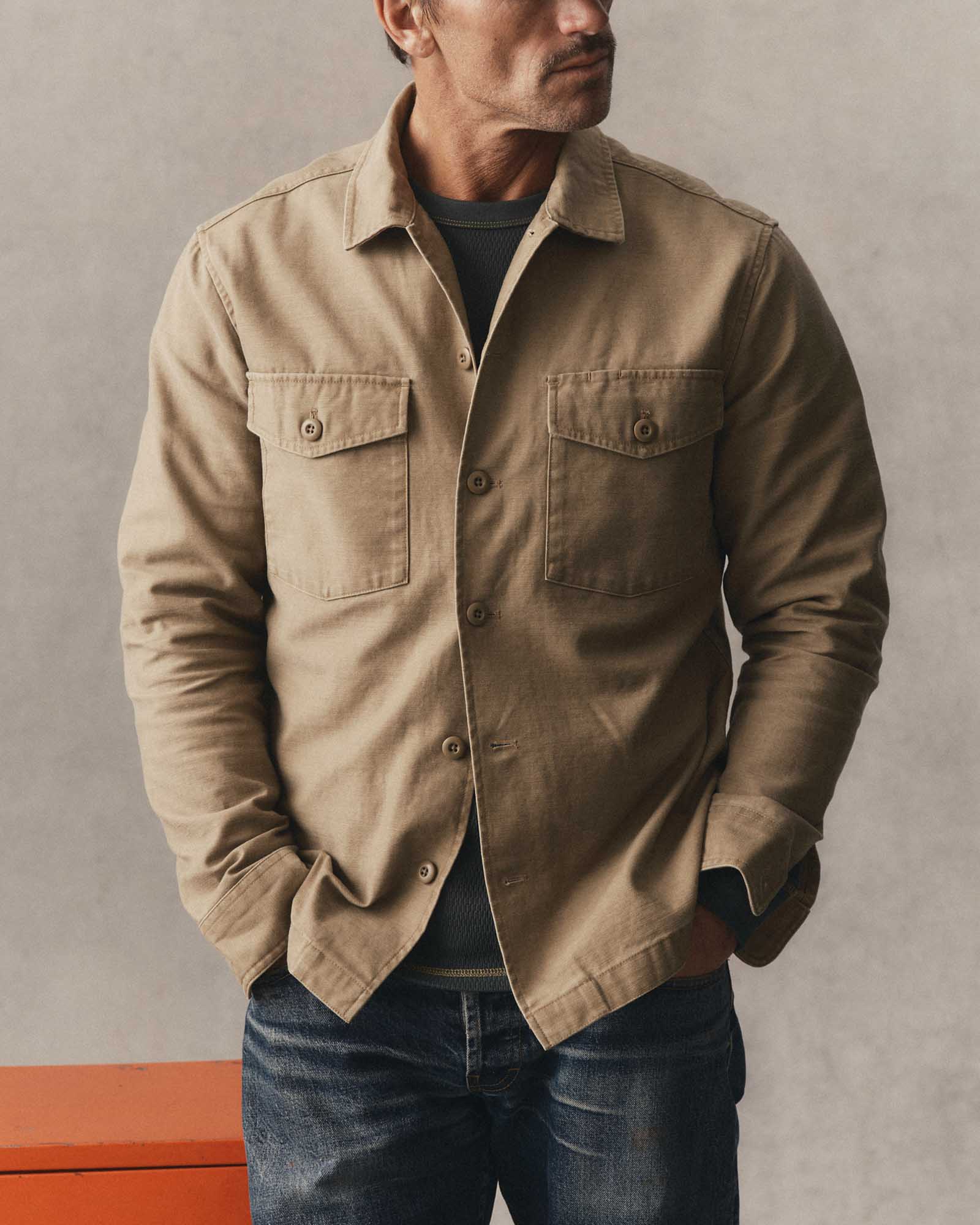 fit model posing in The Surplus Shirt in Khaki Reverse Sateen, Wovens by Taylor Stitch