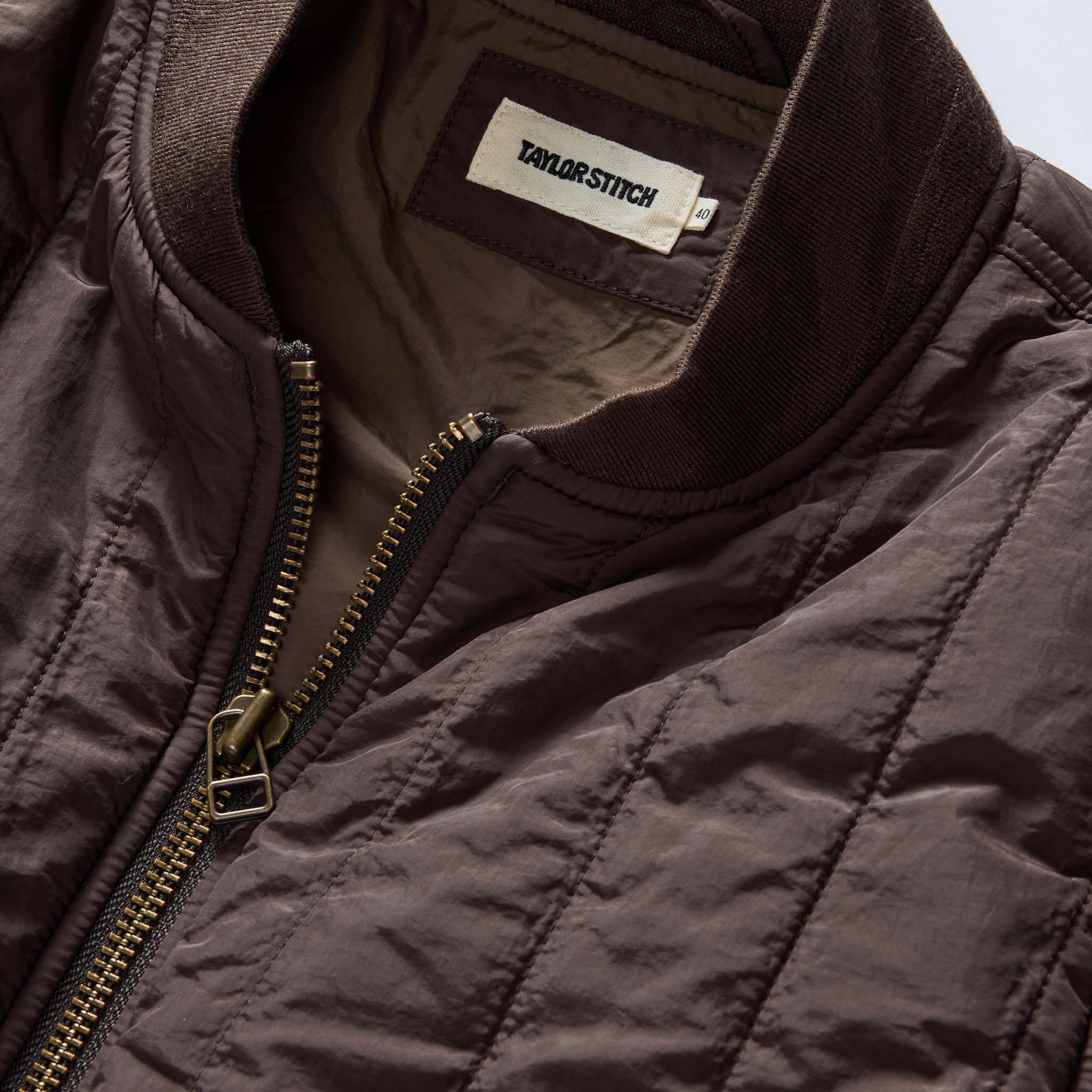 material shot of the collar on The Able Jacket in Soil Quilted Nylon, Outerwear by Taylor Stitch
