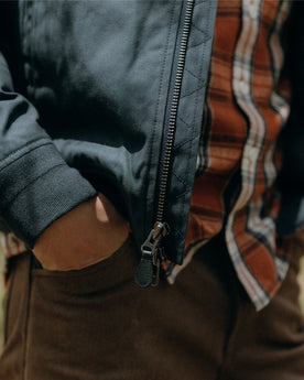 fit model with his hands in his pockets wearing The Camp Pant in Aged Penny Chipped Canvas, Bottoms by Taylor Stitch