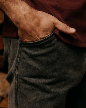 fit model with his hand in his pocket wearing The Camp Pant in Coal Chipped Canvas, Bottoms by Taylor Stitch