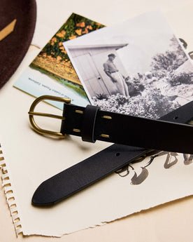 editorial image of The Foundation Belt in Black on a stack of paper, Accessories by Taylor Stitch
