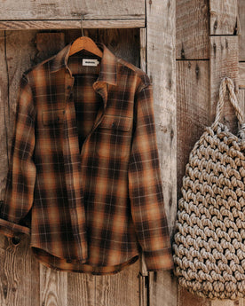 editorial image of The Yosemite Shirt in Bonfire Plaid hanging, Wovens by Taylor Stitch