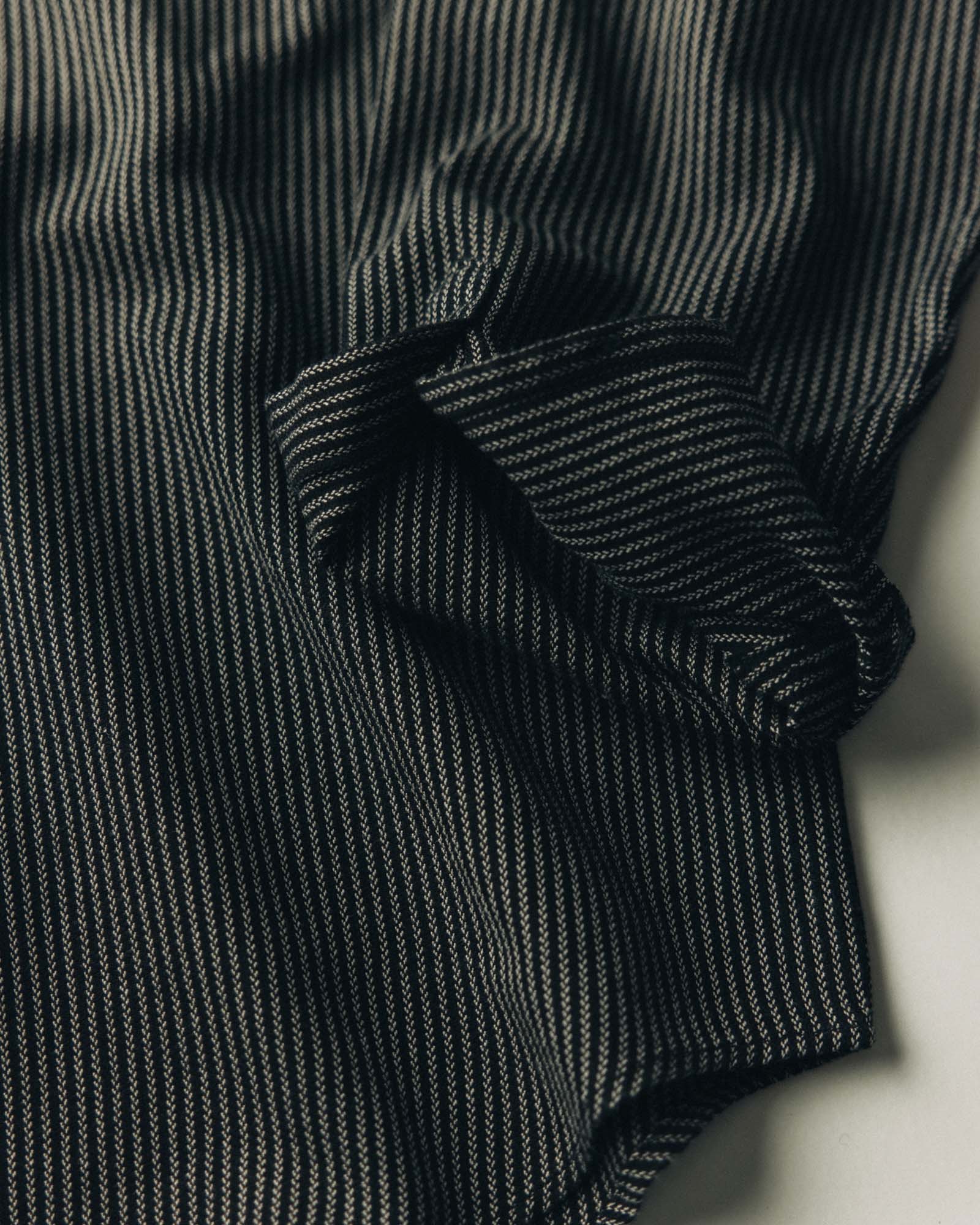 fit model sitting wearing The Jack in Roped Black Indigo, Wovens by Taylor Stitch