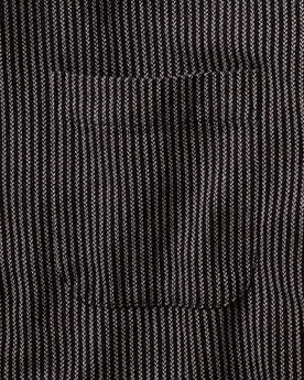 fit model adjusting the cuffs on The Jack in Roped Black Indigo, Wovens by Taylor Stitch